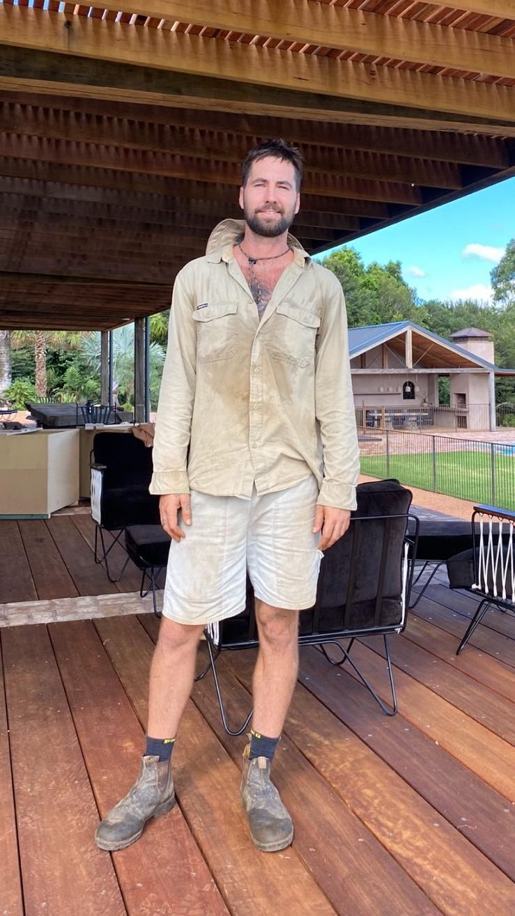 Michael, owner of Tucki Gardens, in his work gear on a timber deck in the Northern Rivers